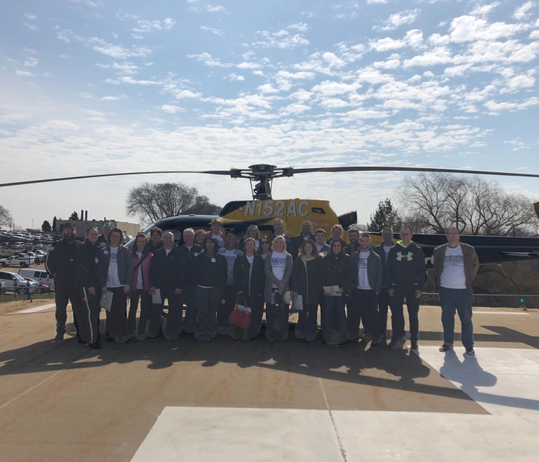 leadership dubuque team next to an emergency helicopter