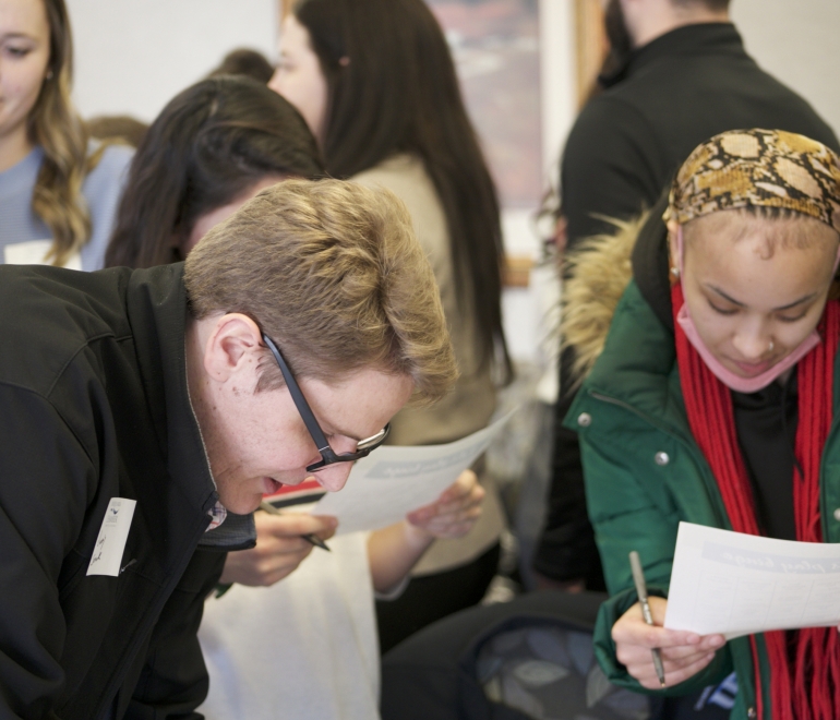 two people reading and writing on paper