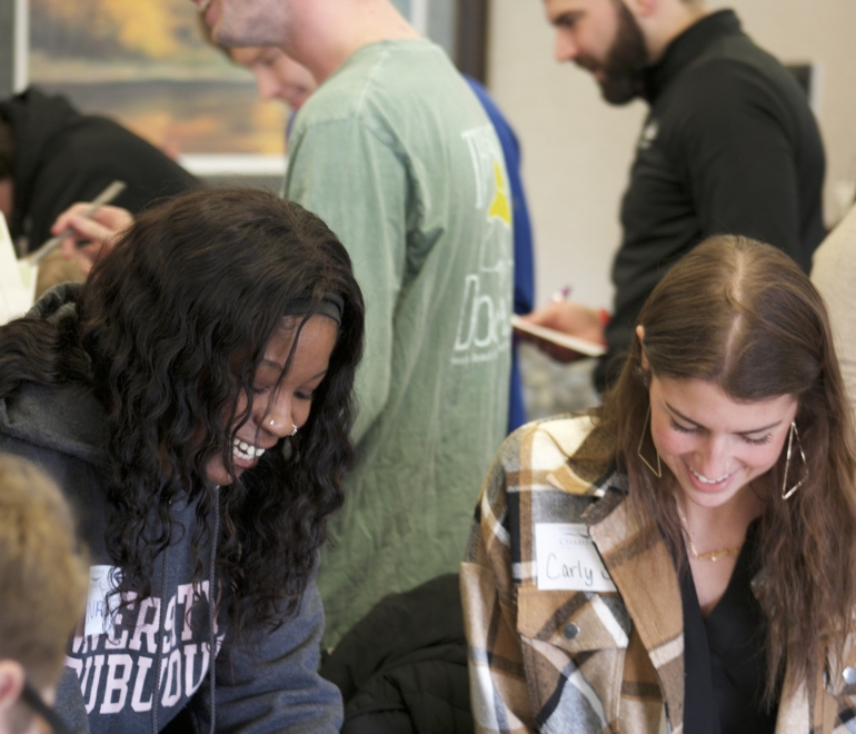 two people reading and writing on paper