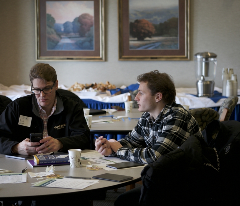 two people talking at a table