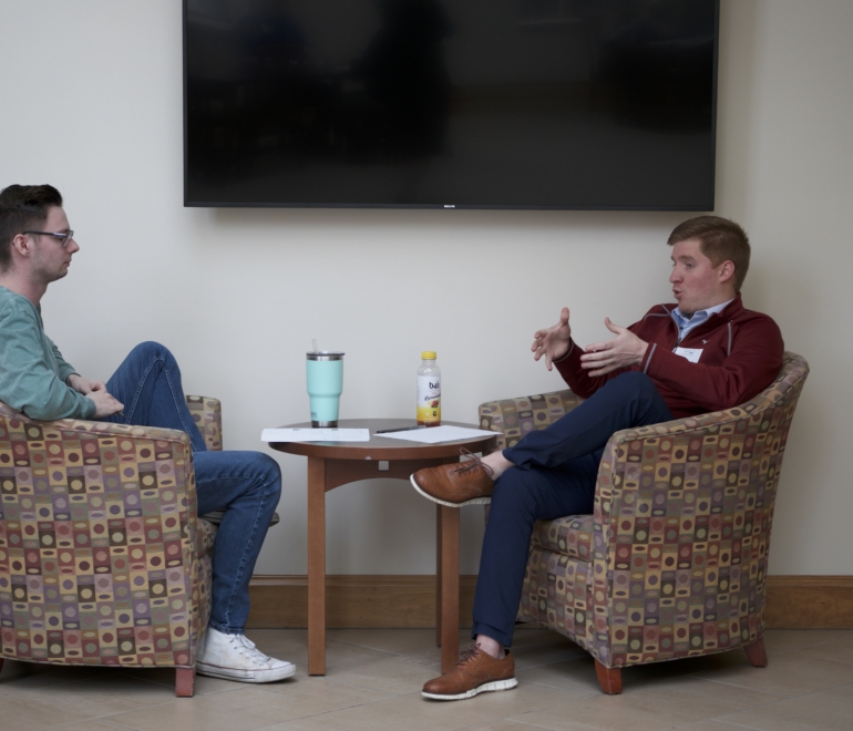 two people talking in lounge chairs