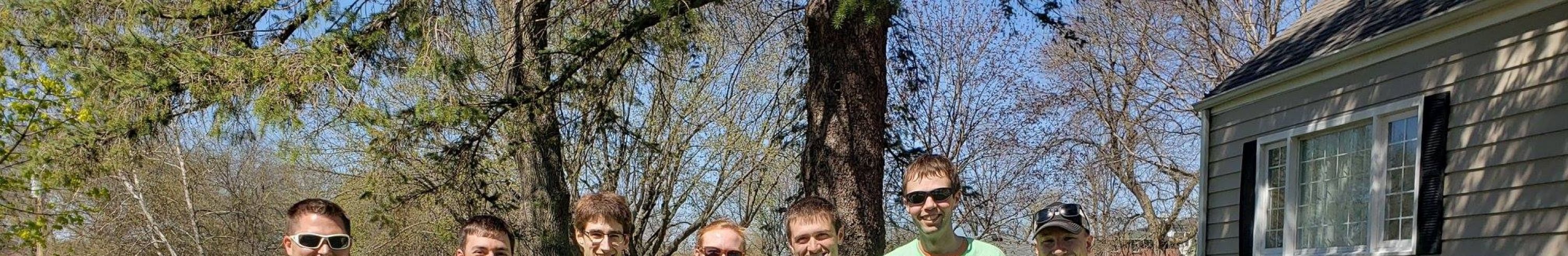Seven people posed in a line for a photo