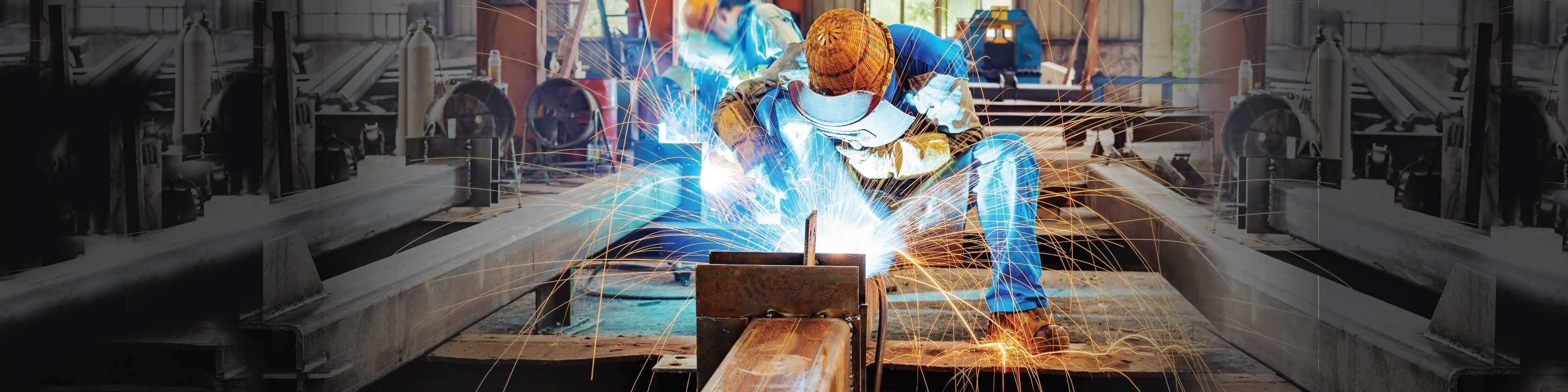 Person in welding mask using a fire torch on metal.