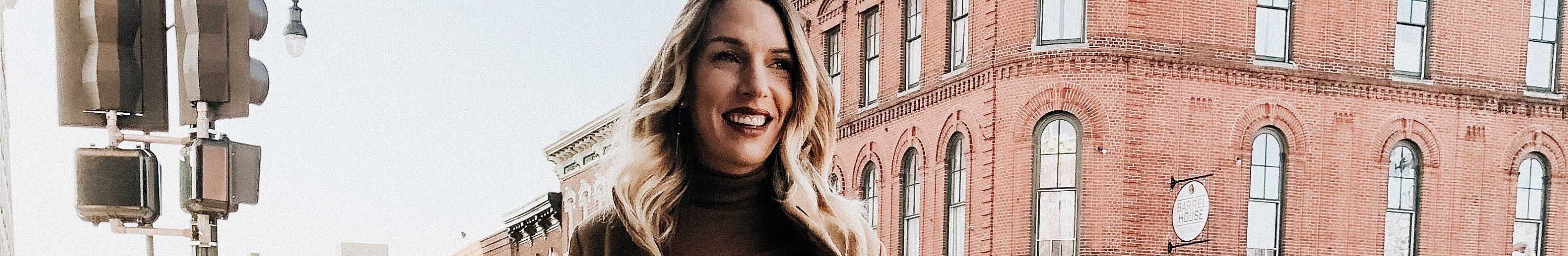 girl holding coffee on downtown Dubuque street