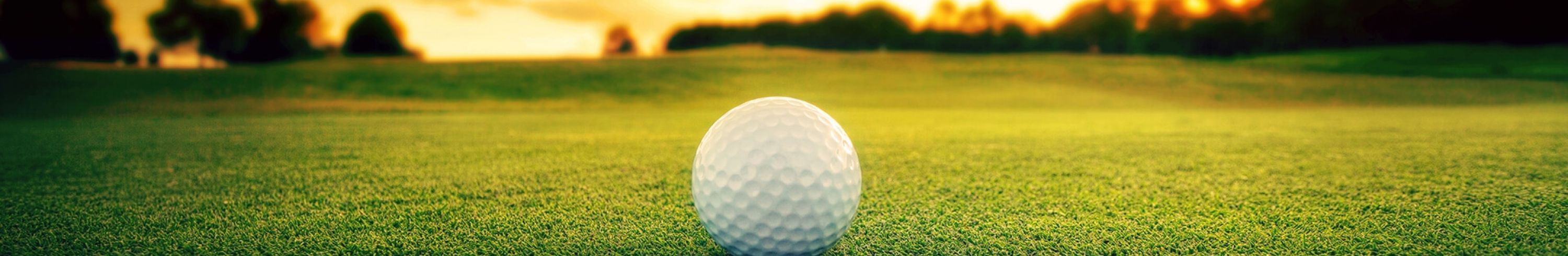 golf ball on golf course at sunset